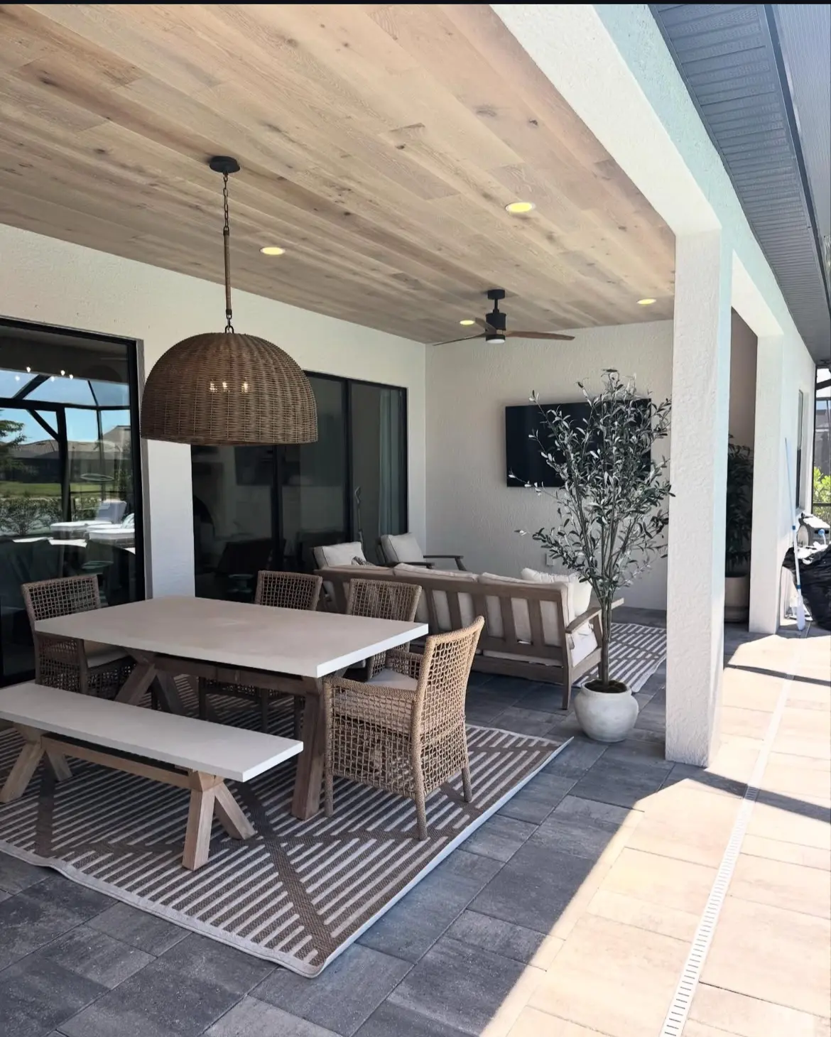 Covered Southwest Florida lanai with a finished wood ceiling and outdoor dining area