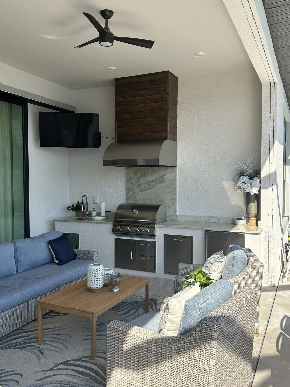 Covered lanai with a custom site-built outdoor kitchen and lounge seating